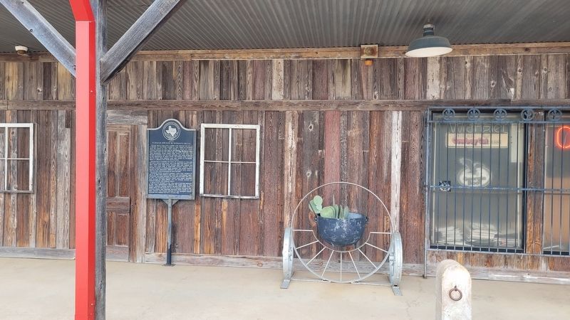 The Site of Norman Springs & Norman Grove Marker on the front porch to the boot store. Click for full size. The Site of Norman Springs & Norman Grove Marker on the front porch to the boot store image. Click for full size.
