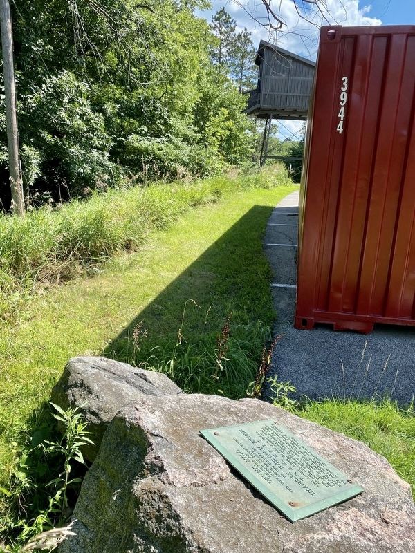 Marker with toboggan slide in the distance (past a storage locker) image. Click for full size.
