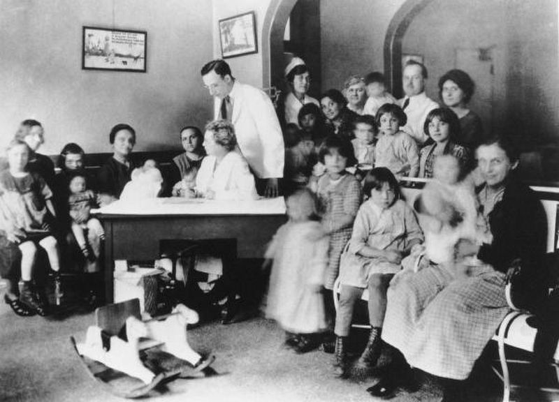 Dr. Florence Siebert sitting at desk in the Phipps Institute Children's Clinic, Philadelphia, PA image. Click for full size.