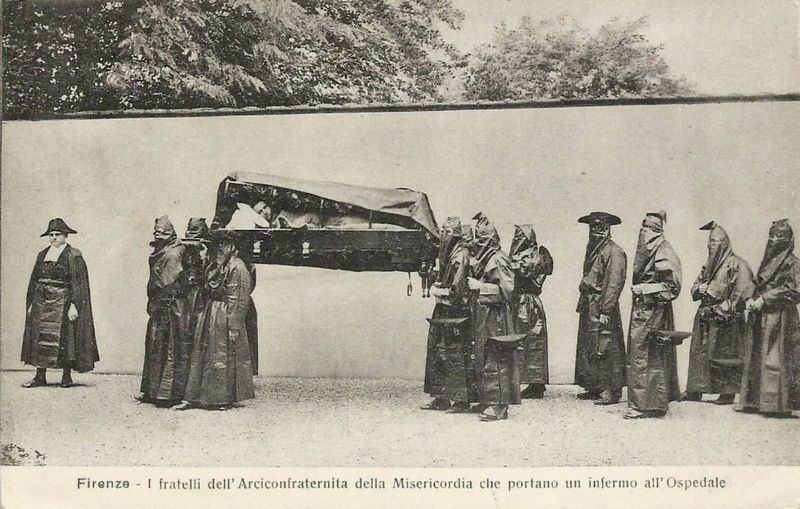 Members carrying a sick person to the hospital image. Click for full size.