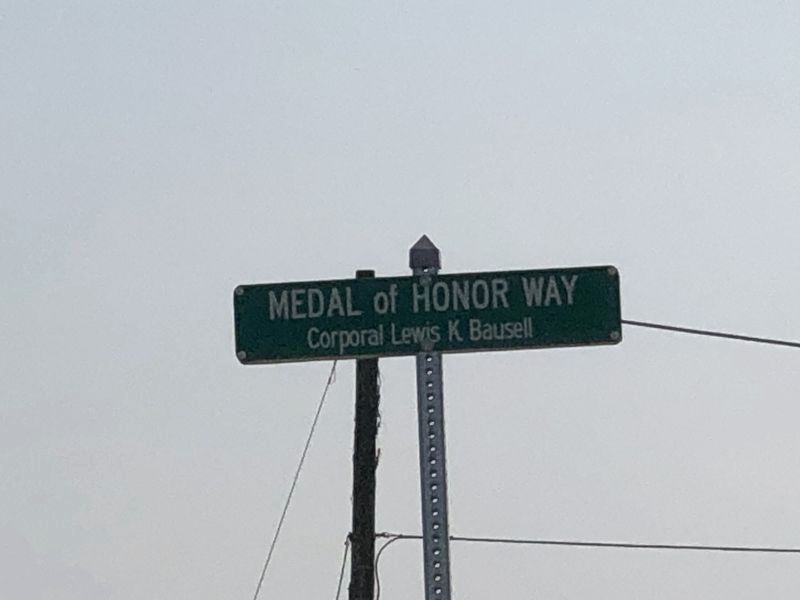 Street sign honoring Corp. Bausell image. Click for full size.
