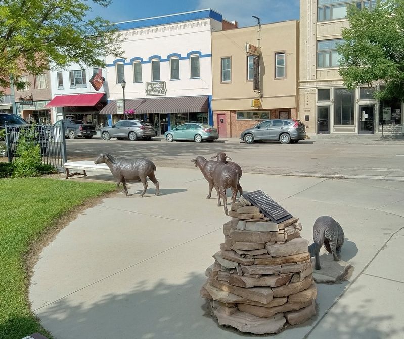 Early Johnson County Marker and bronze statues of a dog herding three sheep image. Click for full size.
