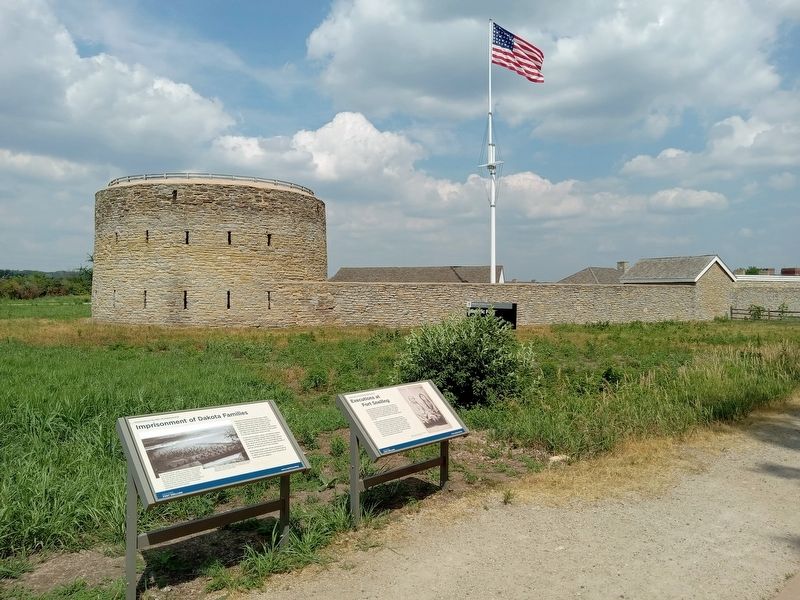 Imprisonment of Dakota Families Marker (left) in front of Historic Fort Snelling image. Click for full size.