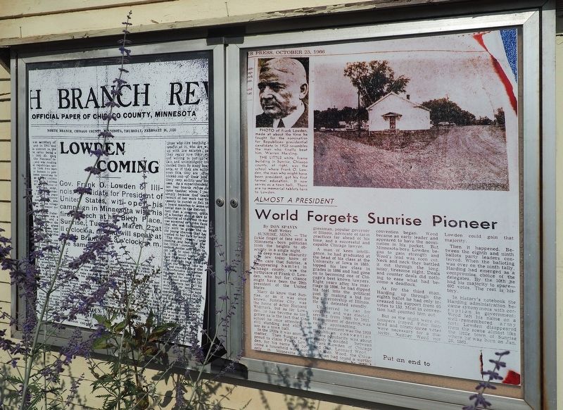 Enlargements of newspaper articles mounted on corner of town hall image. Click for full size.