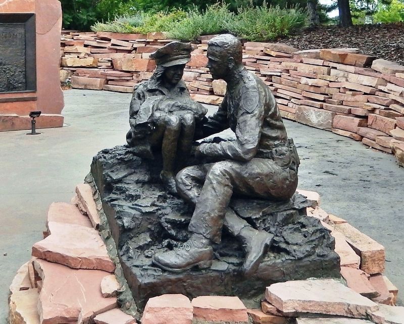 Police Officer with Child (<i>sculpture</i>) image. Click for full size.