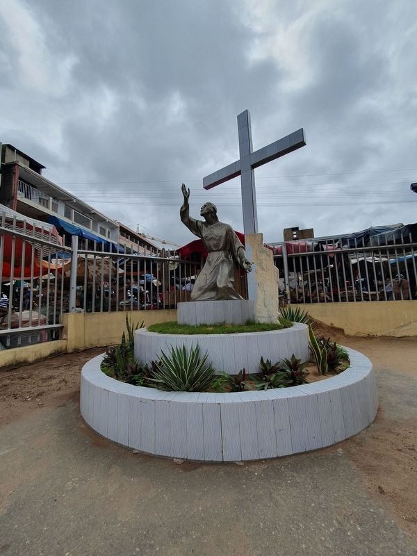 A nearby sculpture of Jesus and the Cross with a map of Togo image. Click for full size.