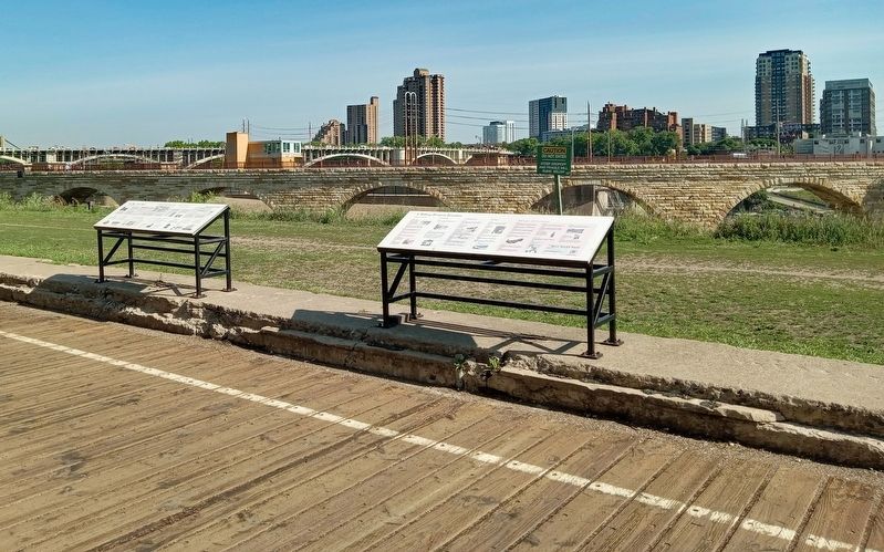The West Side Mills Marker (right) overlooking the Stone Arch Bridge and Mill Ruins Park image. Click for full size.