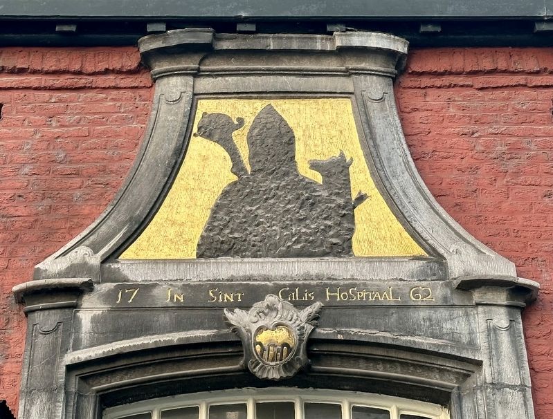 Saint Gillis Hospital detail - above door outline of Saint Gilles with doe and arrow. image. Click for full size.
