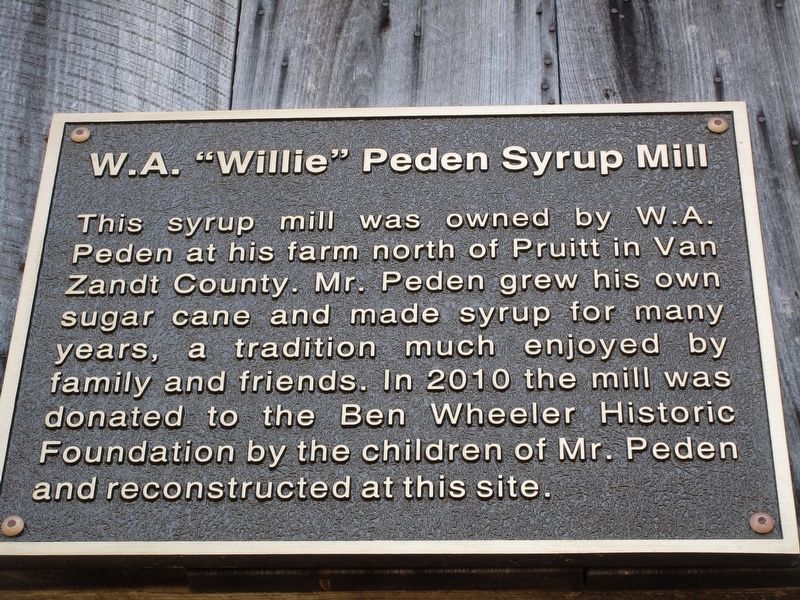 Informational sign above syrup mill image. Click for full size.