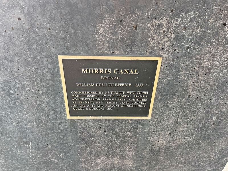 Dedication plaque on the front of the sculpture base. image. Click for full size.