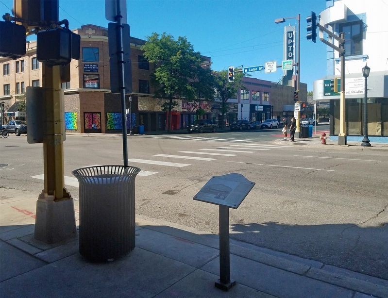 Marker at the southeast corner of Lake and Hennepin, with the Rainbow Building catercorner image. Click for full size.