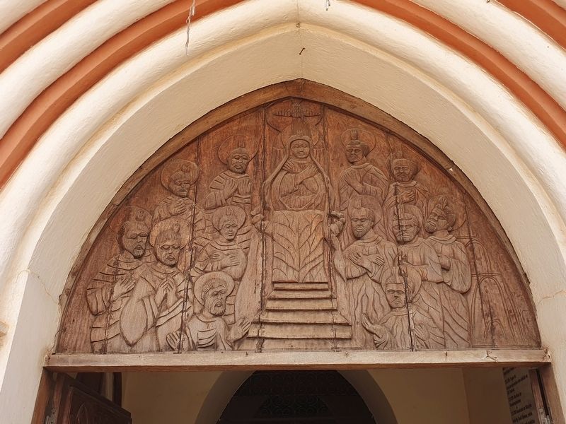Wood engraving over the main entrance to the Cathedral of Kpalimé. Click for full size. Wood engraving over the main entrance to the Cathedral of Kpalimé image. Click for full size.