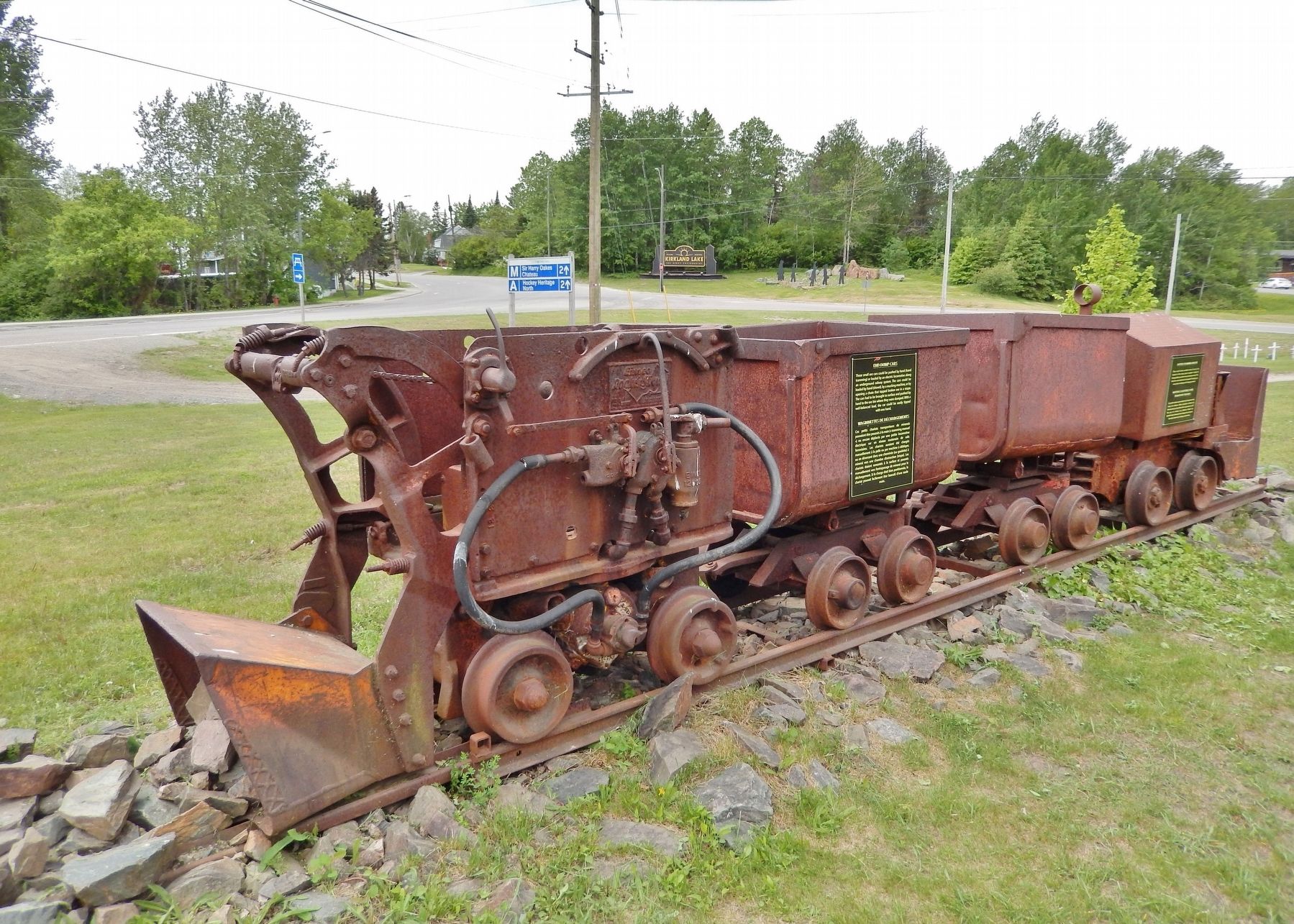 Mucking Machine, Two End Dump Cars and Battery Tramming Motor. Click for full size. Mucking Machine, Two End Dump Cars and Battery Tramming Motor image. Click for full size.