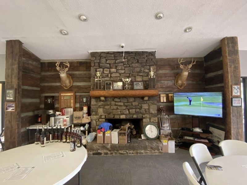 Hand-hewn log wall and stone fireplace image. Click for full size.