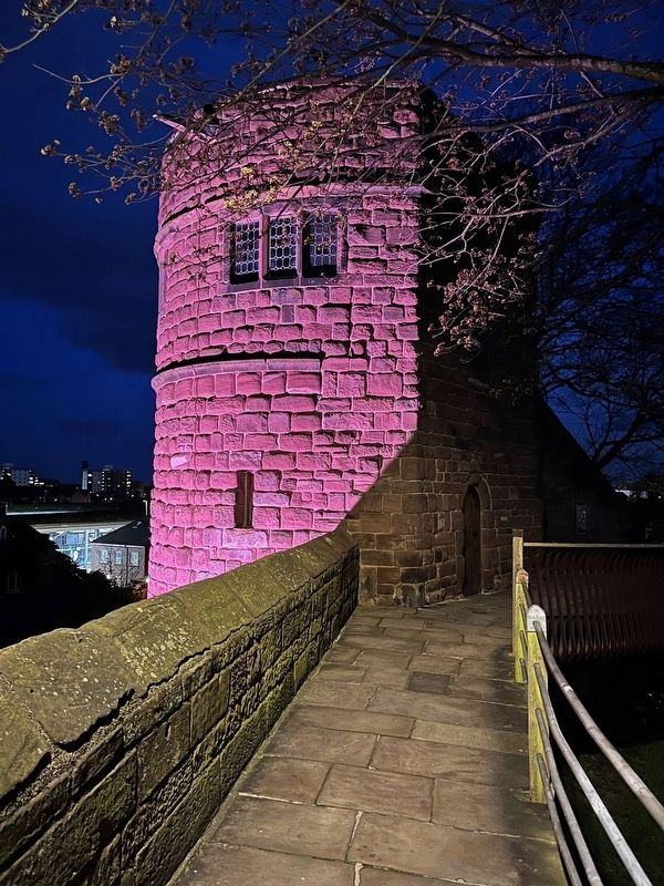 King Charles Tower at night, in colored lights image, Touch for more information