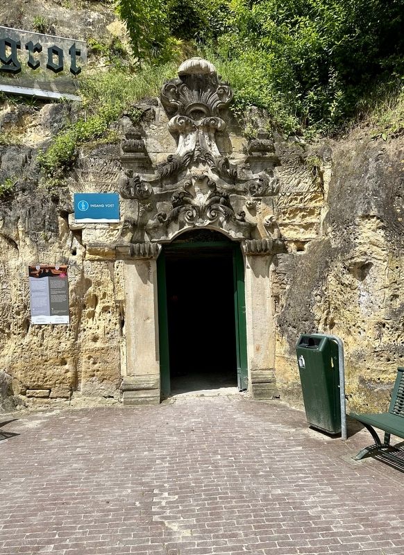 Cave entrance decorated with remnants of a Maastricht church (mentioned on marker) image. Click for full size.