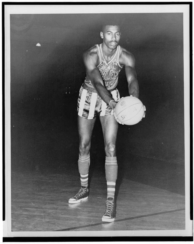 Wilt Chamberlain, full-length portrait, wearing uniform of Harlem Globetrotter's basketball team image. Click for full size.