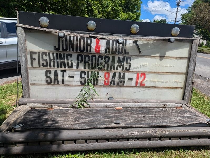 Sign telling about fishing programs at the entrance to Webster Pond image. Click for full size.