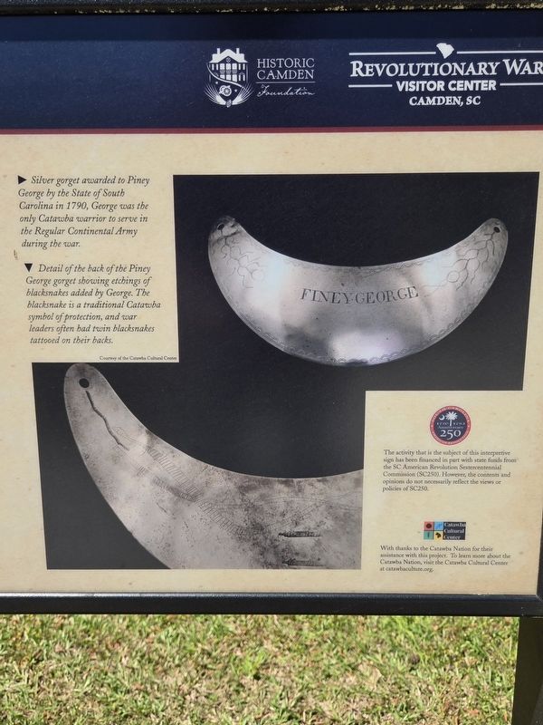 Closeup of silver gorget on the right side of the marker image. Click for full size.