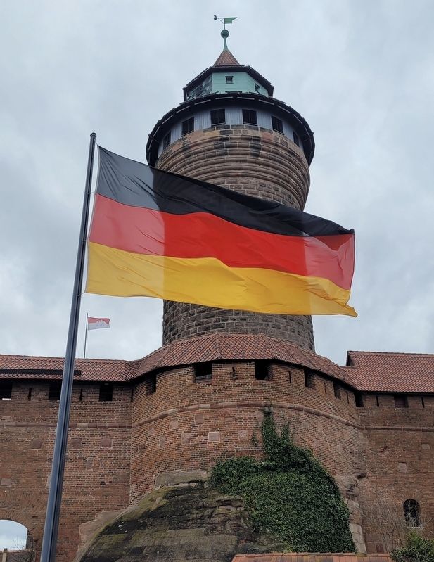 The front view of the Sinwellturm / Sinwell Tower with the German flag. Click for full size. The front view of the Sinwellturm / Sinwell Tower with the German flag image. Click for full size.