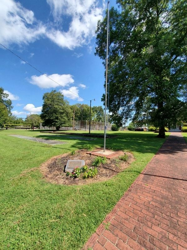 We of Erwin Mills Marker and flagpole to the left of the brick walkwayof the Textile Heritage Center image. Click for full size.