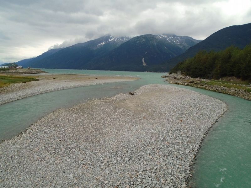 View SW from Skagway River Pedestrian Bridge toward the Taiya Inlet Showing River's Gravel Base. Click for full size. View SW from Skagway River Pedestrian Bridge toward the Taiya Inlet Showing River's Gravel Base image. Click for full size.