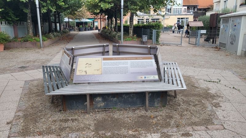 The marker is located on a set of benches image. Click for full size.