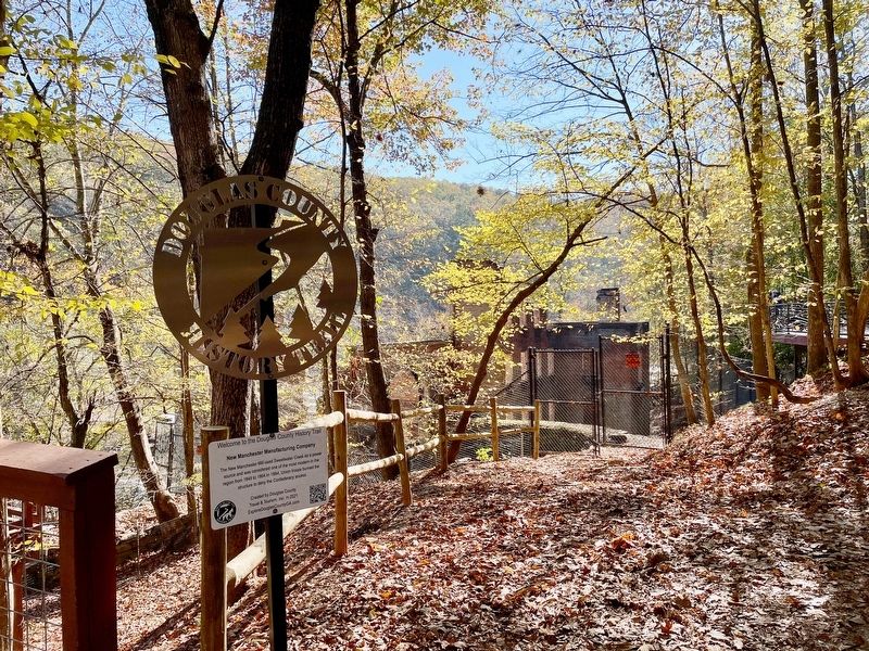 New Manchester Manufacturing Company Marker with Mill ruins in background long Sweetwater Creek.. Click for full size. New Manchester Manufacturing Company Marker with Mill ruins in background long Sweetwater Creek. image. Click for full size.