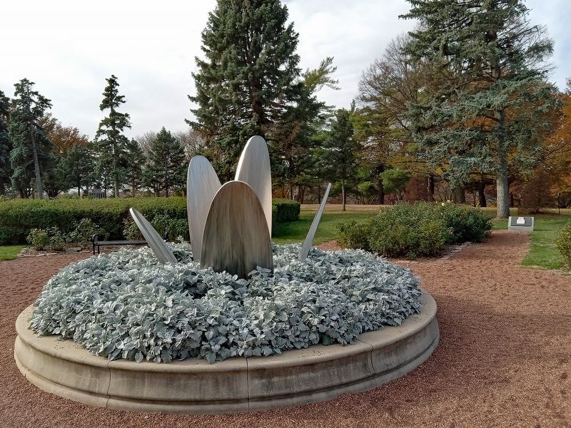 Never Forget Garden Marker (right background) near the centerpiece of the Memorial Park Rose Garden image. Click for full size.