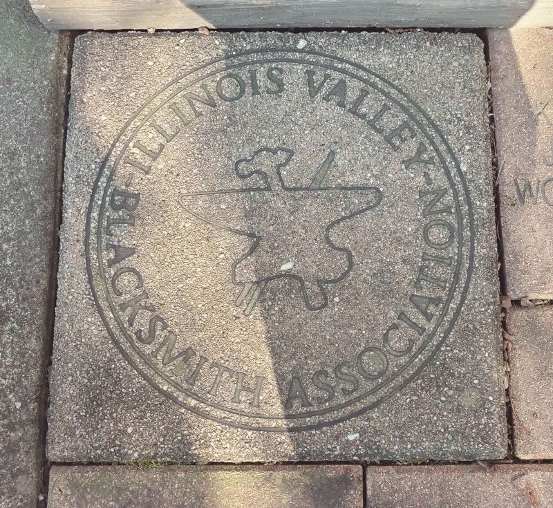 Illinois Valley Blacksmith Association seal, located on the sidewalk near blacksmith shop entrance image. Click for full size.