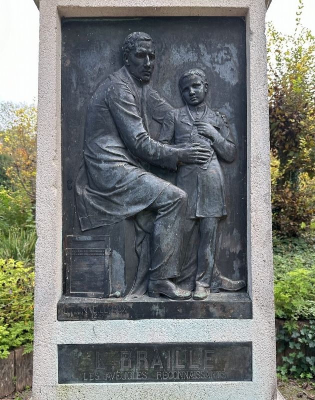 Monument detail - Braille teaching a boy to read image. Click for full size.
