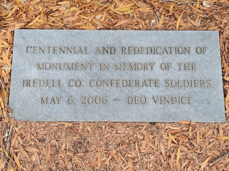 Re-dedication marker at the foot of the east side of the memorial image. Click for full size.
