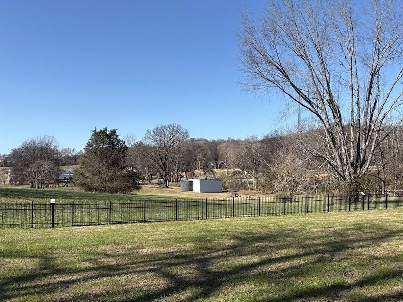 McCain's Academy marker (Seen on the far right on top of the black fence) image. Click for full size.