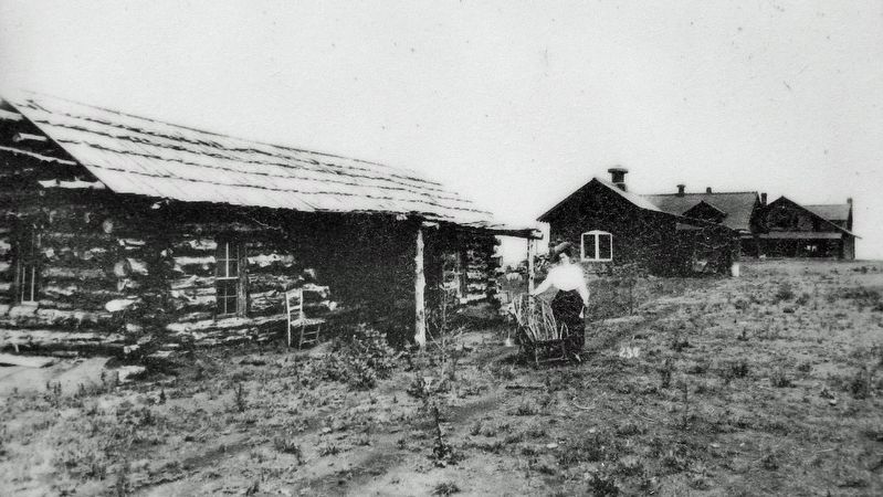 Marker detail: May Lillie stands in front of the log cabin for a movie promotional shot. image. Click for full size.