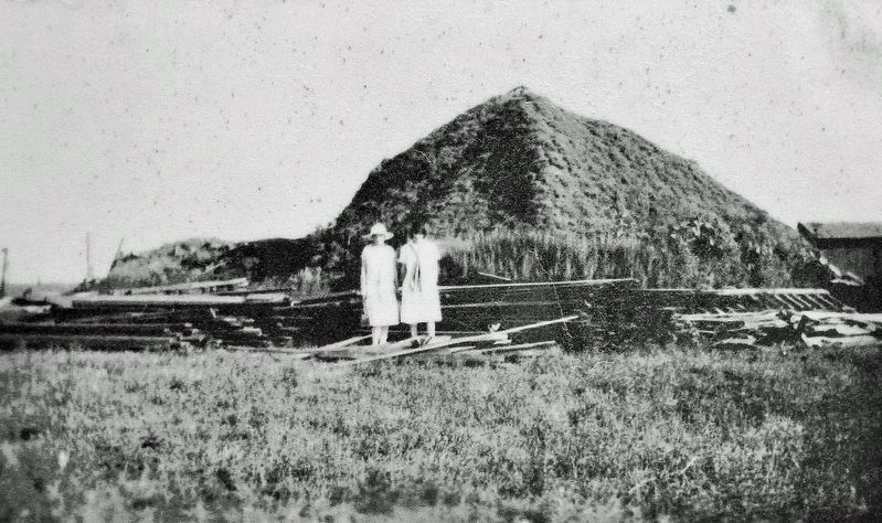 Marker detail: Two women stand in front of the original earth lodge on Blue Hawk Peak.. Click for full size. Marker detail: Two women stand in front of the original earth lodge on Blue Hawk Peak. image. Click for full size.