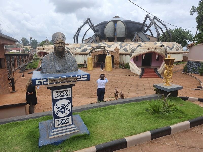 The 19th Sultan of the Bamoun Ibrahim Mbombo Njoya with the Bamoun Museum in the background image. Click for full size.