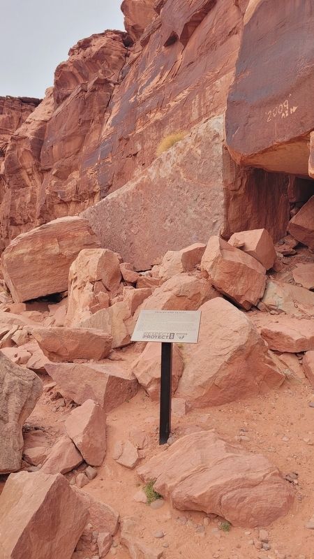 The stone of dinosaur tracks and the Tracks and Traces Marker. Click for full size. The stone of dinosaur tracks and the Tracks and Traces Marker image. Click for full size.