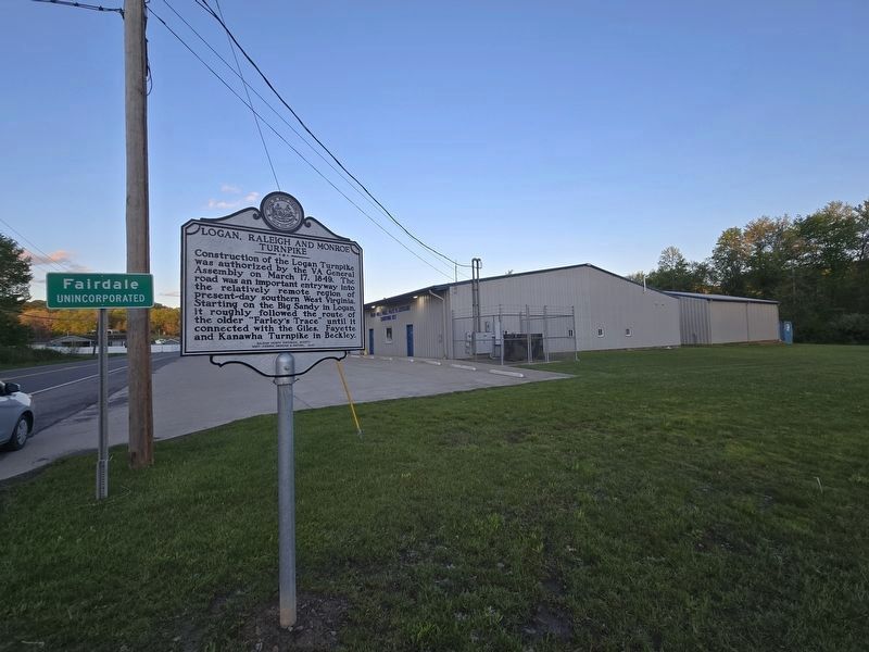 Wide view of Logan, Raleigh and Monroe Turnpike Marker next to Trap Hill VFD image. Click for full size.