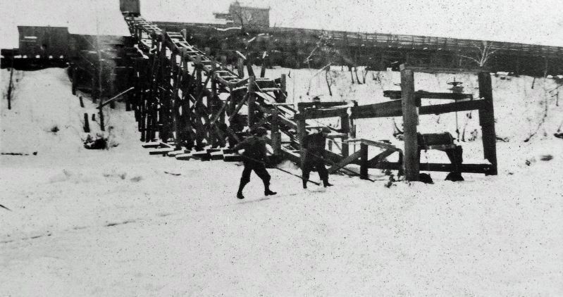 Marker detail: Individual floating ice blocks are moved along a channel to conveyer belt, c. 1920s. Click for full size. Marker detail: Individual floating ice blocks are moved along a channel to conveyer belt, c. 1920s image. Click for full size.
