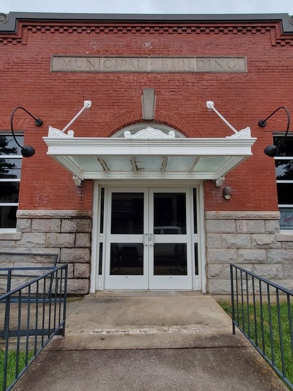 Henderson Municipal Building. Memorial in fenced area to the left. image. Click for full size.
