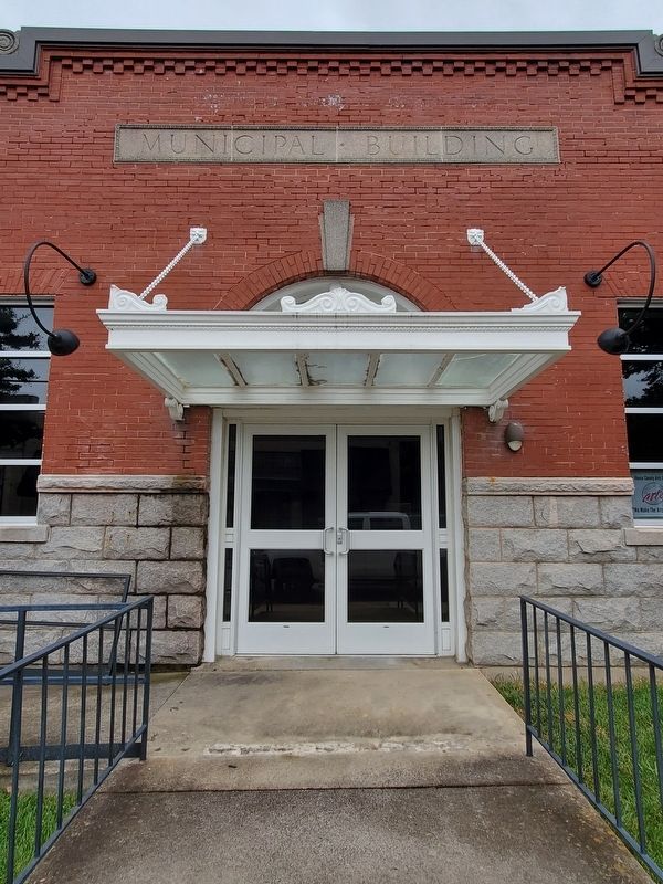 Henderson Municipal Building. Memorial in fenced area to the left.. Click for full size. Henderson Municipal Building. Memorial in fenced area to the left. image. Click for full size.