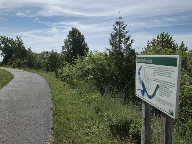 Manistique Boardwalk Marker on the trail next to Lakeshore Memorial Park driveway image. Click for full size.