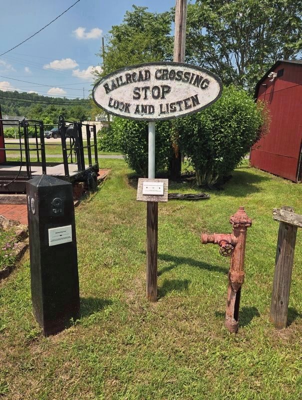 Whistle Stop Post (Left) and Railroad Crossing Sign at This Location image. Click for full size.