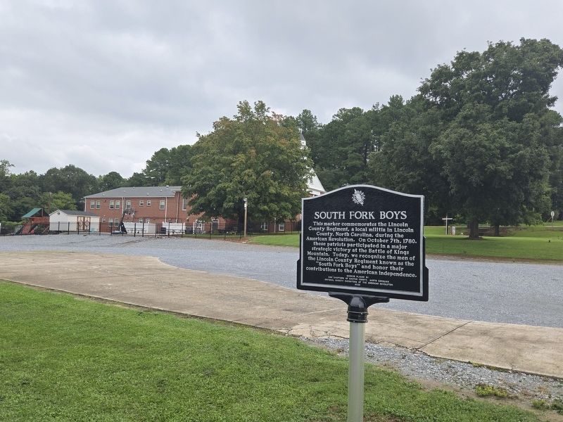 South Fork Boys Marker Crossfix Church in the background. Click for full size. South Fork Boys Marker Crossfix Church in the background image. Click for full size.