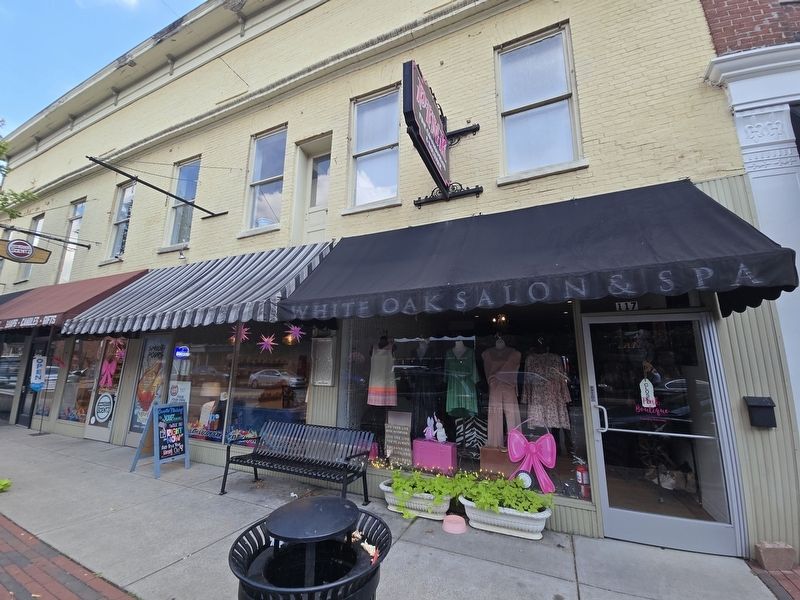 The Smiley - Browne Building Marker between 2 commercial storefronts above the bench image. Click for full size.