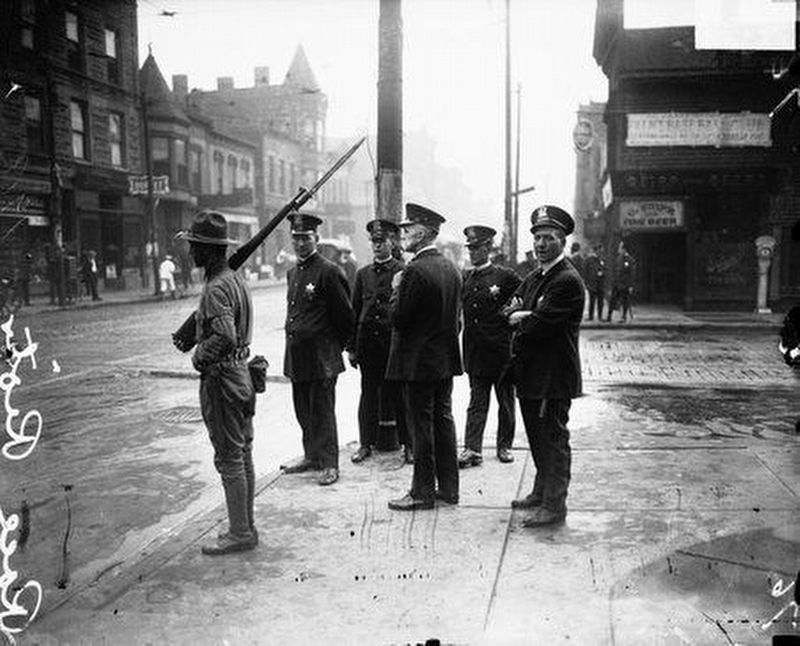 Police patrol the neighborhood during the 1919 race riots image. Click for full size.