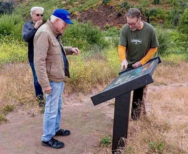 Admiring a MASH Interpretive Sign image. Click for full size.
