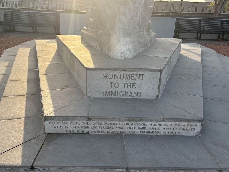 Monument to the Immigrant, text at the base facing the river image. Click for full size.