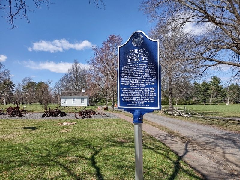 Marker with relocated schoolhouse, farm equipment image. Click for full size.