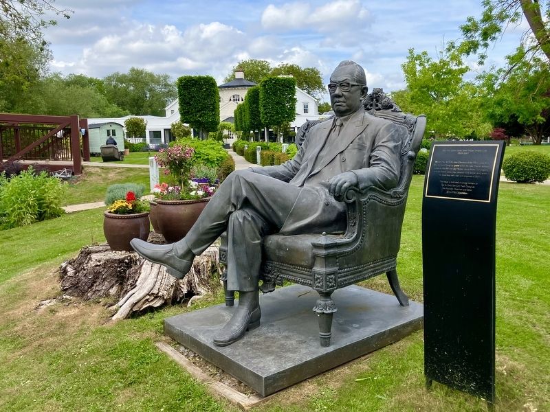 Tan Sri Dato Seri (Dr) marker and statues with Monkey Island Estate hotel in background image. Click for full size.